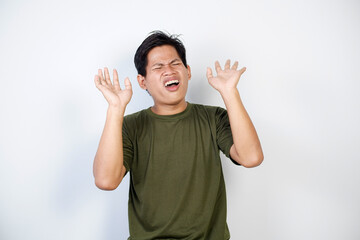 Fototapeta premium Man Expressing Frustration and Emotion With Hands Raised Against Plain Background