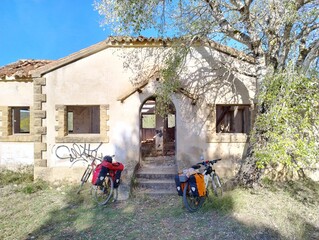 Touring Bicycles Parked Outside Abandoned House in Rural Countryside