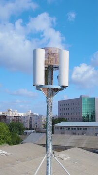Cell phone mini tower base station on a building in a small industrial area for mobile devices - antenna emitting non-ionizing radiation - Vertical video.mov