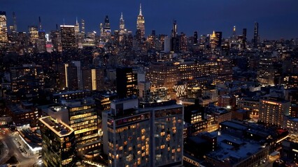 Naklejka premium Night Downtown New York In Manhattan New York United States. Amazing Skysrapers And Traffic On Street Viewed From Above. Building Town Sky Background Illuminated Urban. Town Outdoor Illuminated .