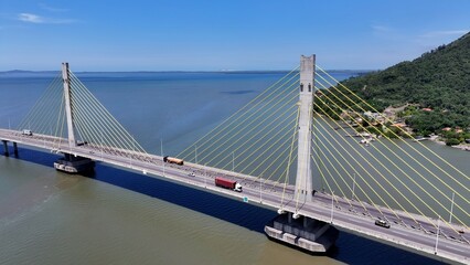 Scenic Viaduct In Laguna Santa Catarina Brazil. Aerial View Of Landmark Bridge Showcasing Its Intricate Design . Town Sky Clouds Backgrounds Urban. Town Panorama. Laguna Santa Catarina. © bydronevideos