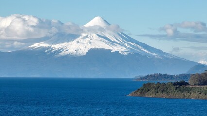 Osorno Vulcan In Puerto Montt Los Lagos Chile. Volcano Showcasing The Raw Power And Beauty Of Nature. Nature Travel Destinations Snow Covered Forest Trees. Exploration Snow Covered Aerial.