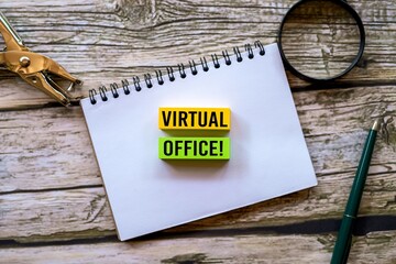 VIRTUAL OFFICE! symbol. VIRTUAL OFFICE! written on a sticky note above a notebook. A beautiful...