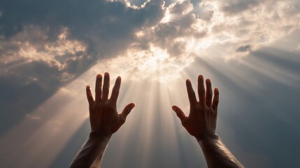 Hands raised toward sky with dramatic sun rays shining through clouds symbolizing faith, prayer, hope, spirituality, and divine inspiration 