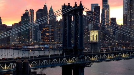 Brooklyn Bridge In Manhattan New York United States. Bridge Showcasing The Traffic Flowing Across In The City. Sunset Sky Clouds Downtown Cityscape. Sunset Downtown Illumination. Manhattan New York.