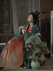 Elegant woman in traditional attire with floral elements Chinese word means flower.