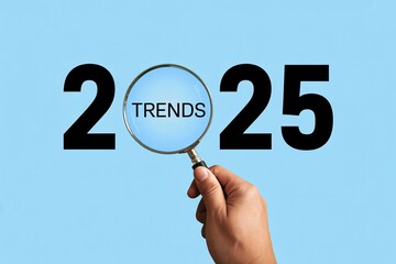 2025 trends concept with magnifying glass future forecast search business innovation minimalist blue background.