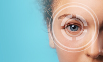 Woman's eye closeup, blue color, over a blue background, with copy space
