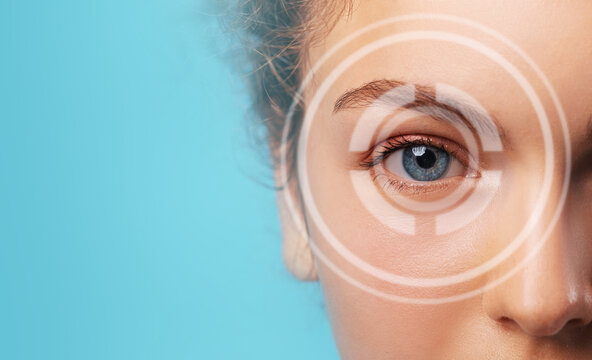 Woman's eye closeup, blue color, over a blue background, with copy space