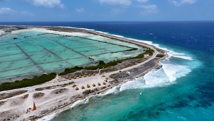 Bonaire Skyline In Kralendijk Bonaire Netherlands Antilles. Turquoise Ocean Waves Gently Crashing On Tropical Beach. Shore Sky Clouds Beach Sea. Outdoor Beach Panning Wide. Kralendijk Bonaire. © bydronevideos