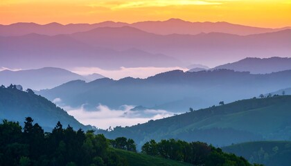 Obraz premium Misty Mountain Layers at Sunrise: A Gradient of Blues, Purples, and Golden Light