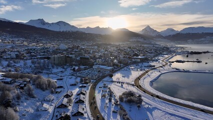 Ushuaia Skyline In Ushuaia Tierra Del Fuego Argentina. Birds Eye View Of Stunning Cityscape With Streets And Buildings. Sunset Snowy Illumination Patagonia Landscape Blizzard.
