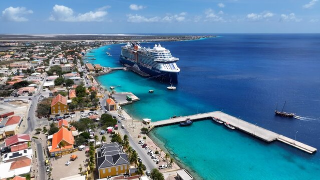 Caribbean Cruise In Kralendijk Bonaire Netherlands Antilles. Large White Cruise Ship Moored On A Calm Blue Ocean. Business Sky Clouds Downtown Cityscape. Outdoor Downtown Panning Wide. - Powered by Adobe