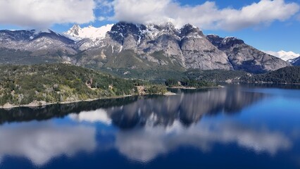 Fototapeta premium Bariloche Skyline In San Carlos De Bariloche Rio Negro Argentina. Tropical River With A Scenic Forest Trees Viewed From Above. Nature Travel Destinations Snow Covered Forest Trees.