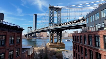 Naklejka premium Manhattan Bridge In Manhattan New York United States. Iconic Structure Of Bridge Connecting Landmarks Streets. Town Clouds Sky Backgrounds Urban. Backgrounds Downtown Panoramic City.