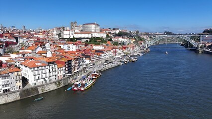 Fototapeta premium Ribeira Pier In Porto Portugal. Aerial View Of Stunning Beach With Crystal Clear Waters. Town Sky Clouds Backgrounds Urban. Town Outdoor Downtown Panning Wide. Porto Portugal.