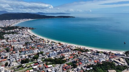 Fototapeta premium Bombinhas Skyline In Bombinhas Santa Catarina Brazil. Bird Eye View Of A Amazing Coastal Beach In The Summer Holiday. Shore Clouds Sky Beach Sea. Shore Travel. Bombinhas Santa Catarina.