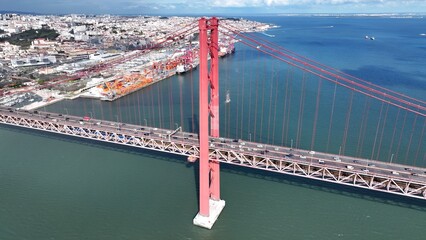 25Th April Bridge In Lisbon Portugal. Iconic Structure Of Bridge Connecting Landmarks Streets....