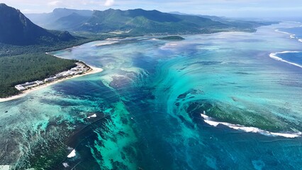 Fototapeta premium Underwater Waterfall In Le Morne Beach Mauritius Island Mauritius. Breathtaking Aerial View Of A Lush Tropical Coastline Scenery. Coast Horizon Seaside Summertime. Coast Panoramic.