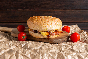 Burger on Wooden Board With Tomatoes