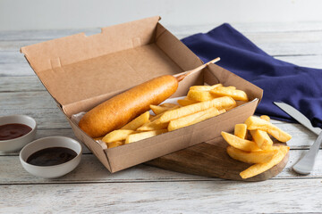 Delicious Corn Dog With Golden Fries on a Table