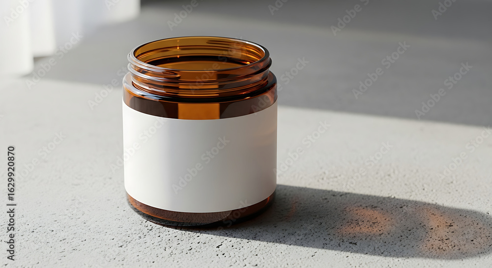 Poster an empty amber glass jar with a blank white label sits on a textured surface, casting a shadow in br
