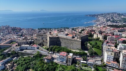 Fototapeta premium Sant Elmo Castle In Naples Campania Italy. Stunning Tropical Coastline Beach Scene Viewed From Above. Town Clouds Sky Backgrounds Urban. Backgrounds Downtown Panoramic City. Naples Campania.