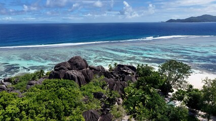 Anse Source D Argent Beach In La Digue Island Victoria Seychelles. Stunning Tropical Coastline Beach Scene Viewed From Above. Shore Sky Clouds Beach Sea. Outdoor Beach Panning Wide.