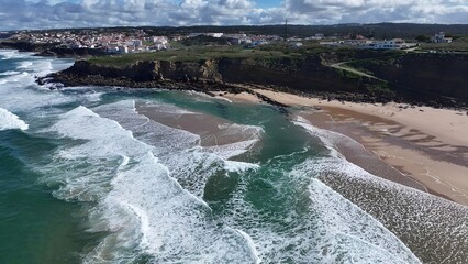 Praia Grande Beach In Sintra District Of Lisbon Portugal. Turquoise Ocean Waves Gently Crashing On Tropical Beach. Holiday Landscape Heaven Vibrant. Holiday Summertime. Sintra District of Lisbon.