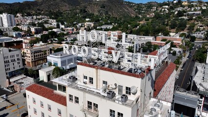 Fototapeta premium Hollywood Roosevelt In Los Angeles California United States. Modern Glass Skyscraper Soars Above A Bustling City. Business Sky Background Downtown Cityscape. Outdoor Downtown Panning Wide.