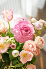 Pastel ranunculus flowers in pink and peach tones captured in natural soft light, perfect for spring weddings, love-themed visuals