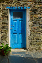 Blue door in traditional stone house in Piodao mountain village. Piodao, Portugal.