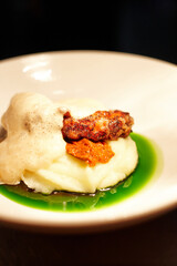 cooked octopus on a bed of puree