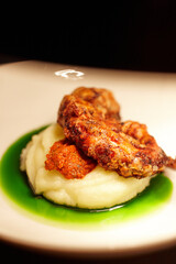 cooked octopus on a bed of puree