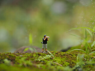 Mini toy of action figure at table with blurred background. Miniature photography concept. Outdoor...