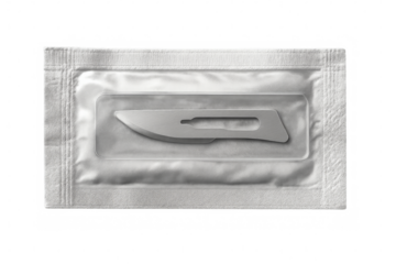 Sterile scalpel blade in transparent packaging on checkered background