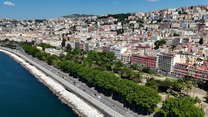Villa Comunale Park In Naples Campania Italy. Aerial View Of Green Space Surrounded By Lush Forest Trees. Business Clouds Sky Downtown Cityscape. Backgrounds Panoramic. Naples Campania. © bydronevideos