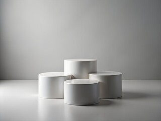 Four minimalist white cylinders arranged as a product display stage