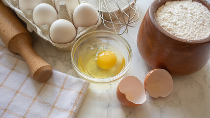 Baking preparation with fresh eggs and flour on a kitchen countertop