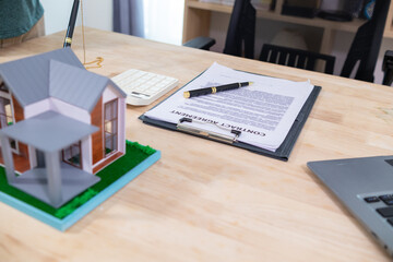 Real estate agents are checking customer information and preparing contract documents selling real estate ready for signing the contract to complete the real estate transaction legally.
