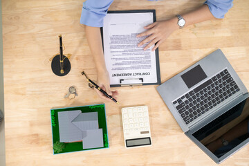 Real estate agents are checking customer information and preparing contract documents selling real estate ready for signing the contract to complete the real estate transaction legally.