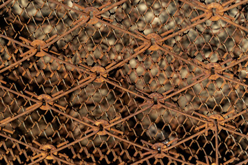 Rusty metal mesh grid with intricate diamond patterns, showcasing weathered textures and aged materials, creating a sense of industrial charm and historical significance in urban environments