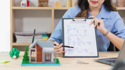 Real estate agents are checking customer information and preparing contract documents selling real estate ready for signing the contract to complete the real estate transaction legally.