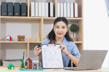 Real estate agents are checking customer information and preparing contract documents selling real estate ready for signing the contract to complete the real estate transaction legally.