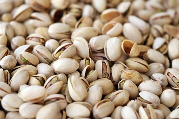 Tasty unpeeled pistachios as background, top view flat lay background