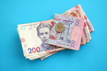 Ukrainian money bills on light blue paper background