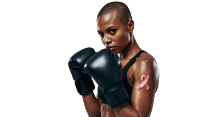 A Warrior Woman with a shaved bare head wearing Boxing Gloves, Breast Cancer Awarenes isolated on transparent background