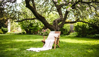 Serene Garden Retreat: Wooden Chair Under Blossoming Tree