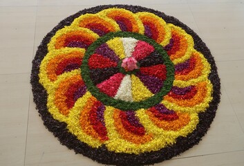 pookalam designs for onam celebrations , pookalam made for part of onam celibration in kerala, india. it also referred to as athapookalam, is often made in a circular shape with flowers on floor