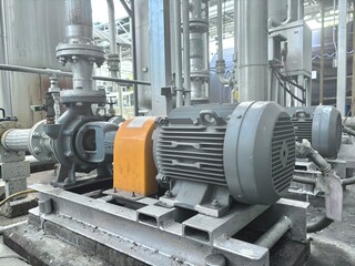 industrial machine detail. Electric motor connected to industrial water pump system in factory...